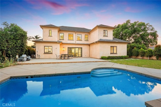 2600 S 2nd Ave, Arcadia, CA 91006 - back of house at dusk with stucco siding, an outdoor pool, and a patio area