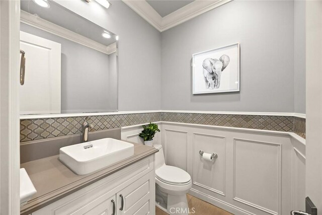 2600 S 2nd Ave, Arcadia, CA 91006 - bathroom featuring ornamental molding, vanity, wainscoting, and a decorative wall