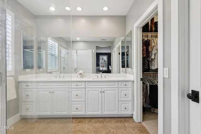 3224 Lisbon Ln, Oxnard, CA 93036 - full bath with a shower stall, double vanity, a spacious closet, baseboards, and recessed lighting