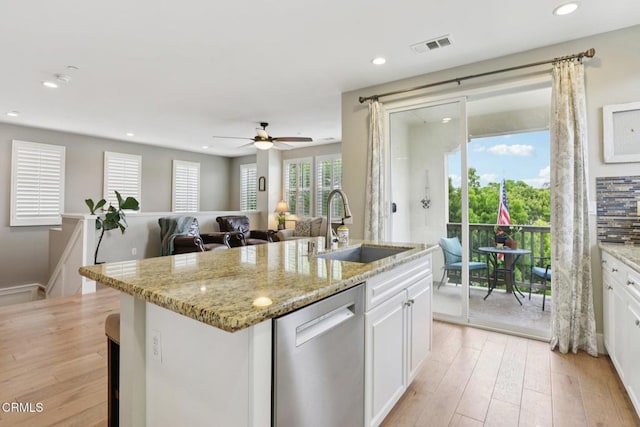 3224 Lisbon Ln, Oxnard, CA 93036 - kitchen with stainless steel dishwasher, a sink, light wood-style floors, white cabinetry, and recessed lighting