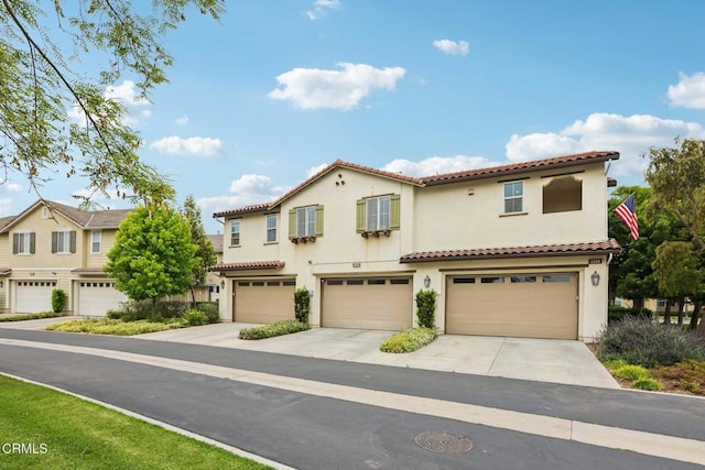 3224 Lisbon Ln, Oxnard, CA 93036 - view of front of property with a tile roof, stucco siding, a garage, and driveway