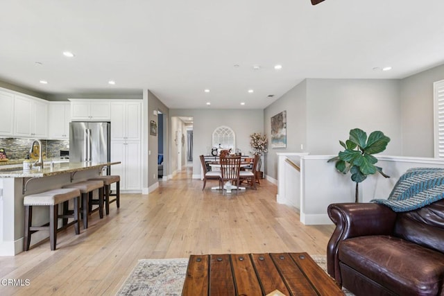 3224 Lisbon Ln, Oxnard, CA 93036 - living room with light wood-type flooring, recessed lighting, and baseboards