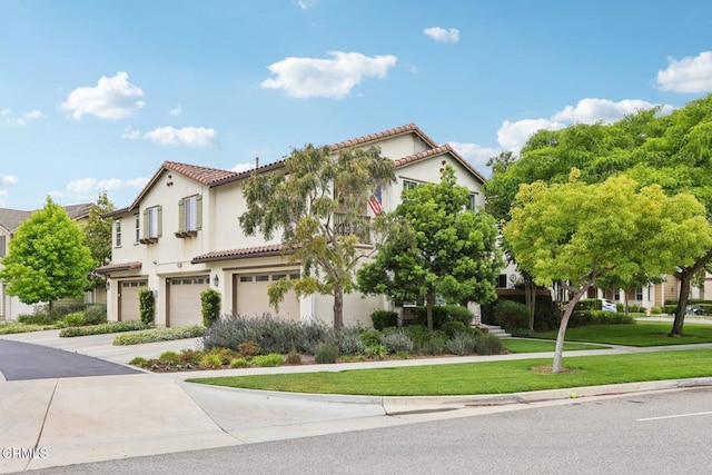 3224 Lisbon Ln, Oxnard, CA 93036 - view of front facade featuring a garage, a tile roof, stucco siding, a front yard, and driveway