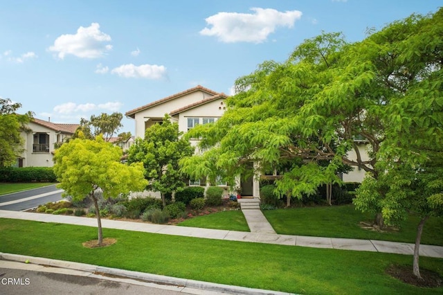 3224 Lisbon Ln, Oxnard, CA 93036 - obstructed view of property with a front lawn, stucco siding, and a tiled roof
