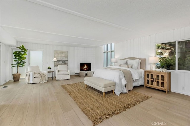 1385 Terrace Way, Laguna Beach, CA 92651 - bedroom featuring wood finished floors, multiple windows, and a lit fireplace
