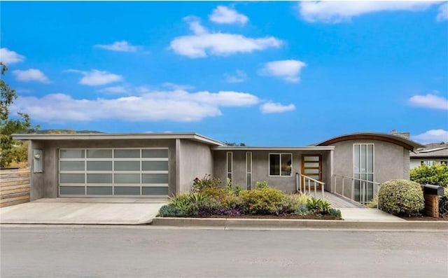 1385 Terrace Way, Laguna Beach, CA 92651 - view of front facade featuring stucco siding, concrete driveway, and a garage
