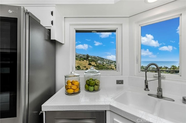 1385 Terrace Way, Laguna Beach, CA 92651 - kitchen view of freestanding refrigerator, white cabinets, and tile countertops