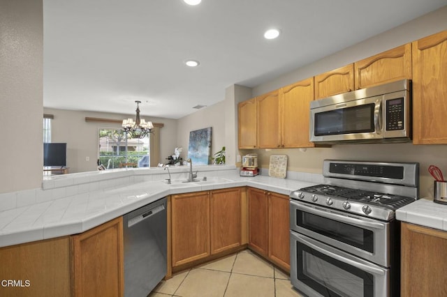 1323 Lost Point Ln, Oxnard, CA 93030 - kitchen featuring stainless steel appliances, a chandelier, a peninsula, tile counters, and recessed lighting