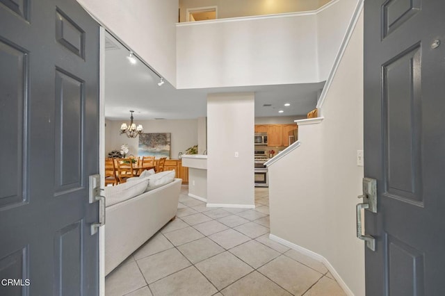 1323 Lost Point Ln, Oxnard, CA 93030 - foyer entrance featuring rail lighting, light tile patterned floors, a chandelier, and recessed lighting