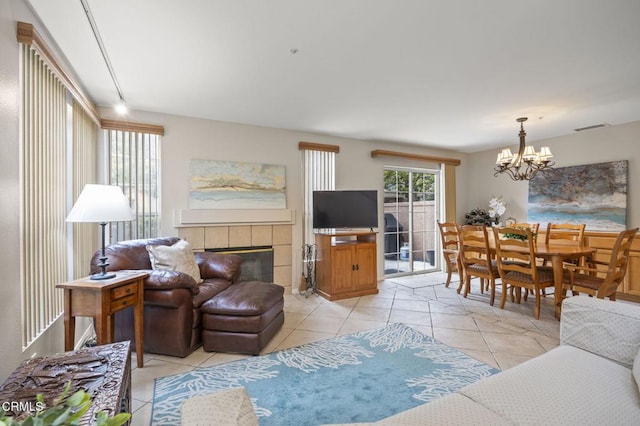 1323 Lost Point Ln, Oxnard, CA 93030 - living area featuring a chandelier, light tile patterned floors, and a tiled fireplace