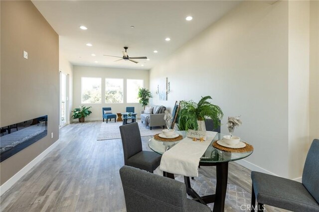 453 N 13th St, Grover Beach, CA 93433 - dining area with recessed lighting, light wood-type flooring, a ceiling fan, and a glass covered fireplace