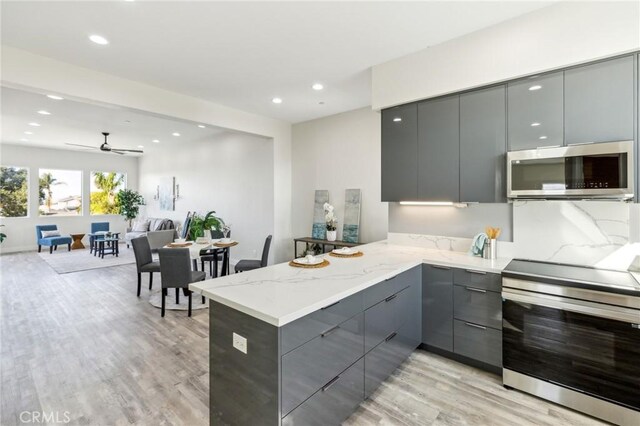 453 N 13th St, Grover Beach, CA 93433 - kitchen with gray cabinets, appliances with stainless steel finishes, modern cabinets, a peninsula, and recessed lighting