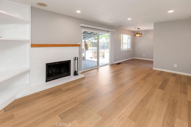 3760 Fielding Cir, Sacramento, CA 95826 - unfurnished living room featuring a fireplace, baseboards, light wood-type flooring, and recessed lighting