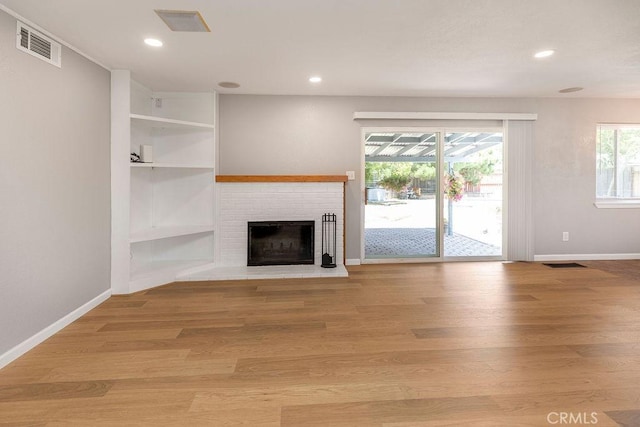 3760 Fielding Cir, Sacramento, CA 95826 - unfurnished living room featuring a brick fireplace, baseboards, recessed lighting, and light wood-style flooring