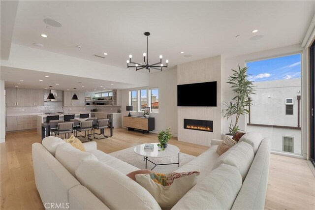 222 2nd St, Hermosa Beach, CA 90254 - living area featuring a fireplace, recessed lighting, light wood-type flooring, and a chandelier