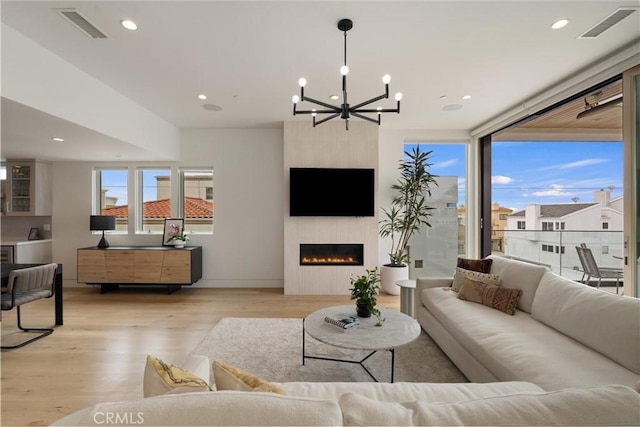 222 2nd St, Hermosa Beach, CA 90254 - living room featuring light wood-type flooring, a chandelier, a large fireplace, and recessed lighting