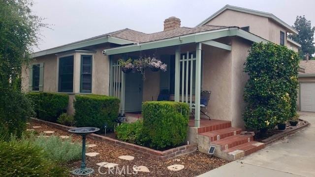 9083 Olive St, Temple City, CA 91780 - property entrance featuring stucco siding, concrete driveway, and a chimney