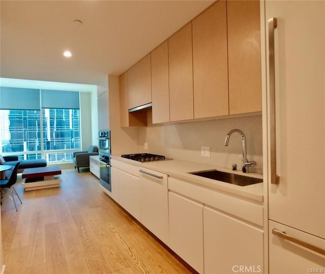 877 Francisco St Unit 1903, Los Angeles, CA 90017 - kitchen with a sink, gas cooktop, light countertops, light wood finished floors, and recessed lighting