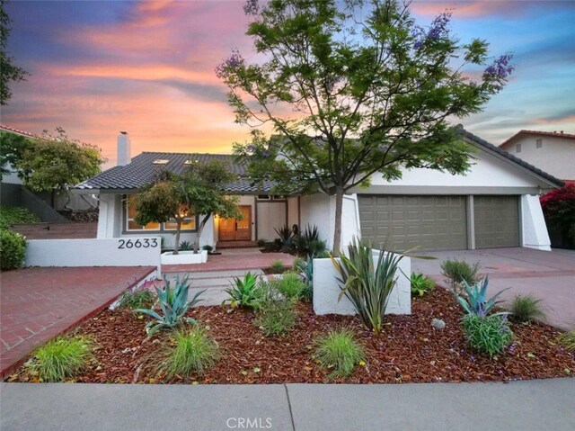 26633 Academy Dr, Palos Verdes Peninsula, CA 90274 - view of front of property with concrete driveway, a garage, a chimney, a tile roof, and stucco siding