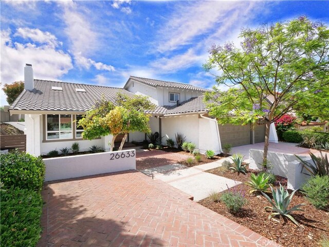 26633 Academy Dr, Palos Verdes Peninsula, CA 90274 - view of front of house featuring stucco siding, a tile roof, a chimney, driveway, and a garage