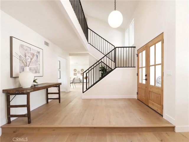 26633 Academy Dr, Palos Verdes Peninsula, CA 90274 - foyer entrance featuring stairway, wood finished floors, a high ceiling, and french doors
