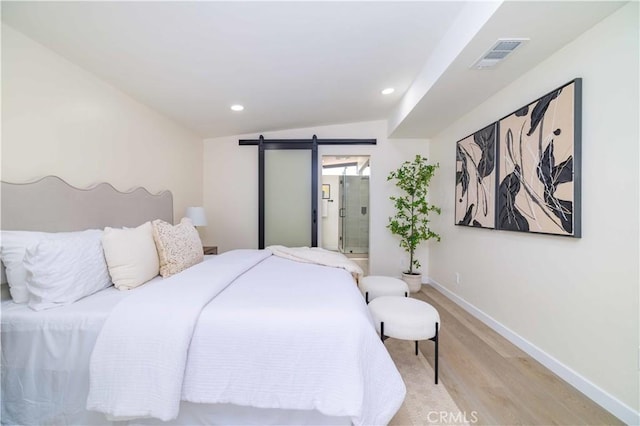 3567 Mount Everest Blvd, San Diego, CA 92111 - bedroom with light wood-style floors, vaulted ceiling, a barn door, recessed lighting, and ensuite bath