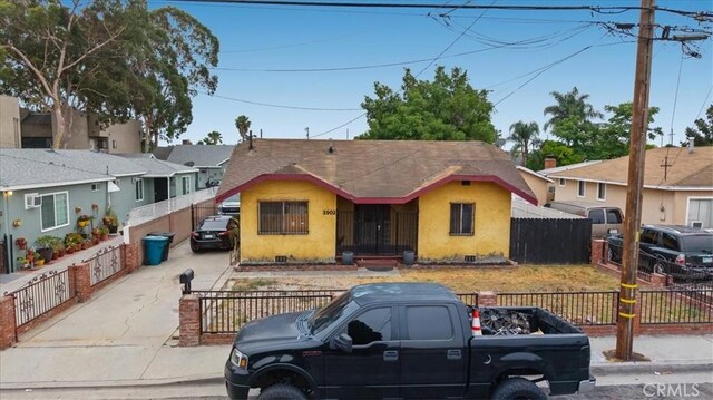 3902 Live Oak St, Cudahy, CA 90201 - bungalow-style home featuring stucco siding, driveway, and a fenced front yard