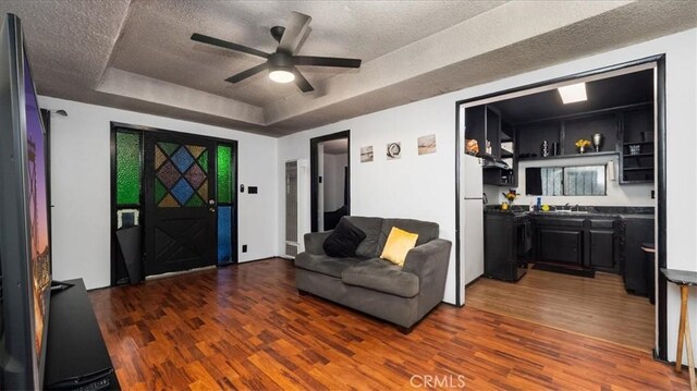 3902 Live Oak St, Cudahy, CA 90201 - living room featuring a raised ceiling, wood finished floors, a textured ceiling, and ceiling fan