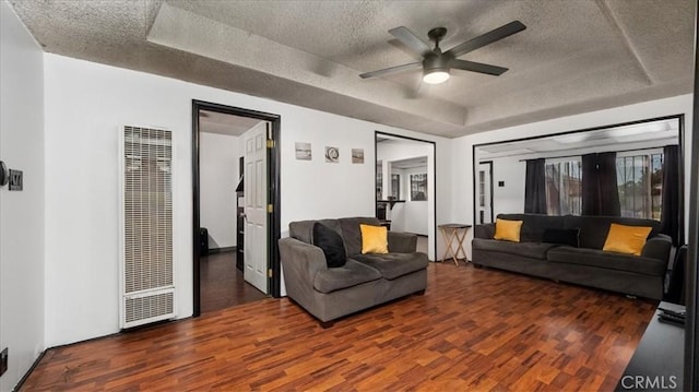 3902 Live Oak St, Cudahy, CA 90201 - living area with a heating unit, a tray ceiling, wood finished floors, a textured ceiling, and a ceiling fan