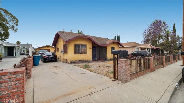 3902 Live Oak St, Cudahy, CA 90201 - bungalow-style house featuring a fenced front yard, stucco siding, and driveway