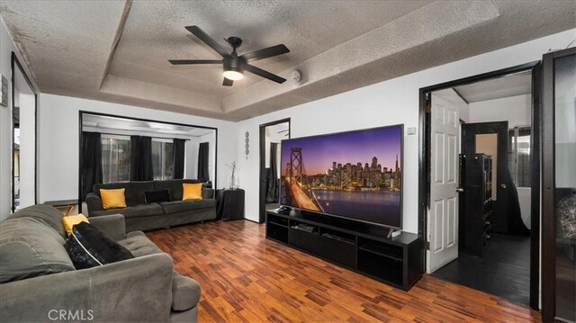3902 Live Oak St, Cudahy, CA 90201 - living area featuring a tray ceiling, wood finished floors, ceiling fan, and a textured ceiling