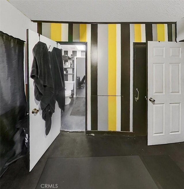 3902 Live Oak St, Cudahy, CA 90201 - interior space with concrete flooring, toilet, and a textured ceiling