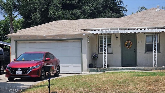 934 W 28th St, San Bernardino, CA 92405 - view of front facade featuring stucco siding, a shingled roof, an attached garage, a front lawn, and driveway