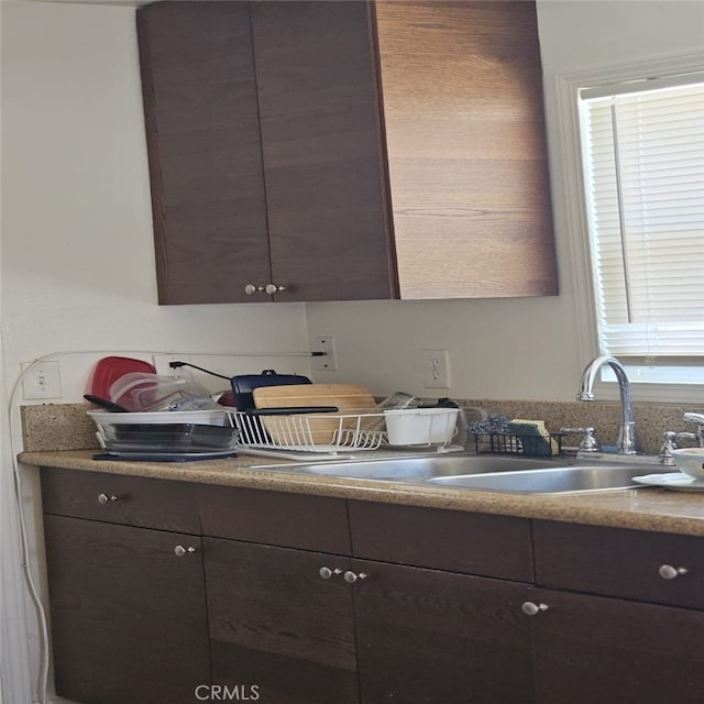934 W 28th St, San Bernardino, CA 92405 - kitchen featuring dark brown cabinetry and light countertops