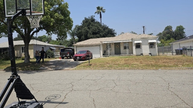 934 W 28th St, San Bernardino, CA 92405 - view of front of property with a garage, driveway, and stucco siding