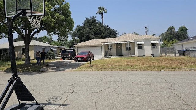 934 W 28th St, San Bernardino, CA 92405 - view of front of property featuring a garage, driveway, and stucco siding