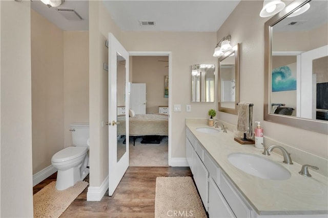 3074 Mountain Top Dr, Highland, CA 92346 - full bath with ensuite bathroom, wood finished floors, double vanity, and toilet