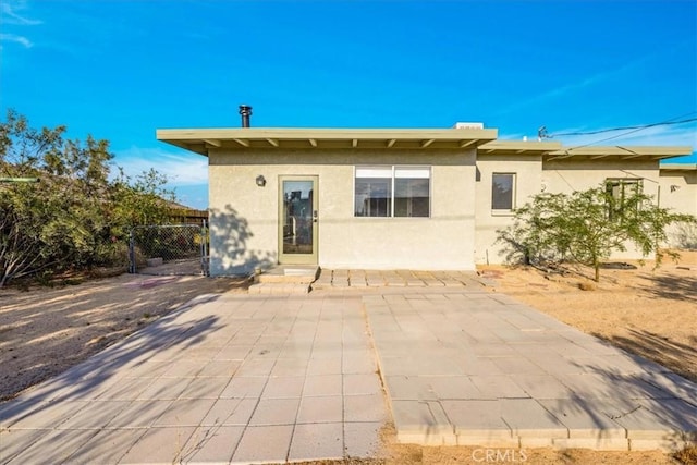 6646 Quail Spring Ave Unit 29, Palms, CA 92277 - back of house with stucco siding, a patio, and a gate