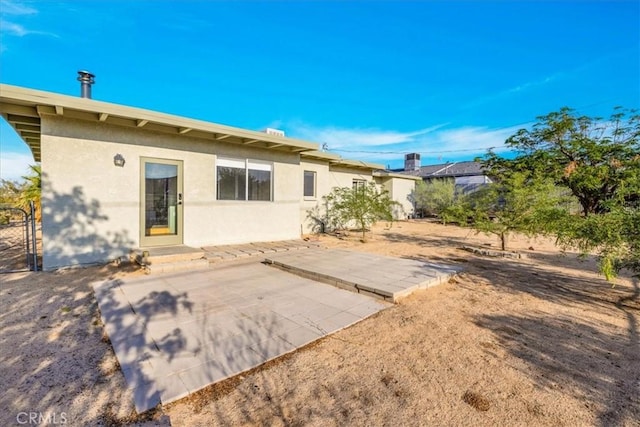 6646 Quail Spring Ave Unit 29, Palms, CA 92277 - back of property featuring stucco siding and a patio area