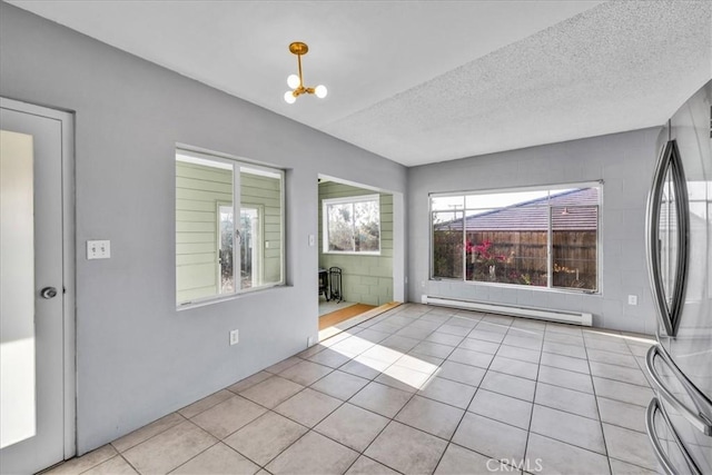 6646 Quail Spring Ave Unit 29, Palms, CA 92277 - tiled empty room featuring a baseboard radiator and a textured ceiling