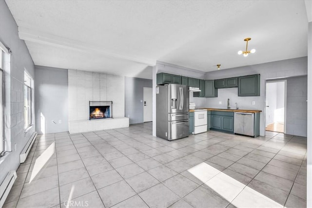 6646 Quail Spring Ave Unit 29, Palms, CA 92277 - kitchen featuring stainless steel appliances, a baseboard radiator, under cabinet range hood, open floor plan, and a textured ceiling