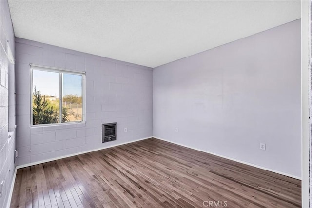 6646 Quail Spring Ave Unit 29, Palms, CA 92277 - unfurnished living room featuring hardwood / wood-style floors, heating unit, and a fireplace