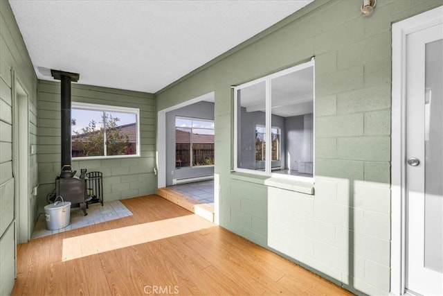 6646 Quail Spring Ave Unit 29, Palms, CA 92277 - sunroom / solarium with a wood stove and a baseboard heating unit