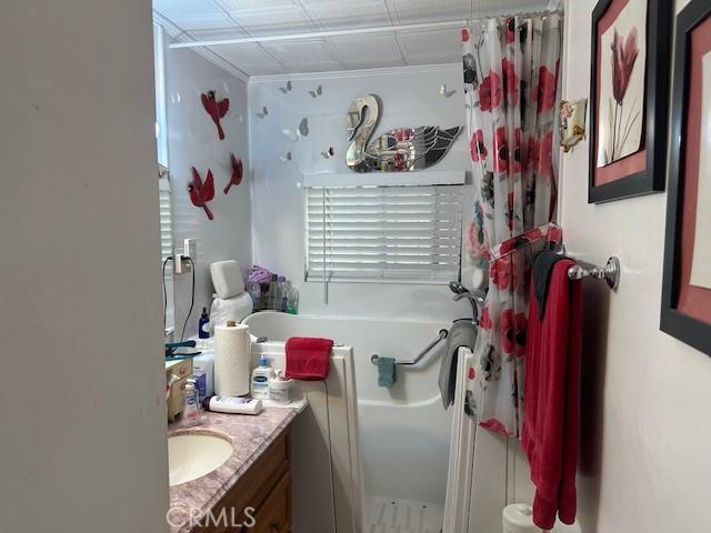 2440 Merrywood St, Pomona, CA 91767 - bathroom with ornamental molding, a bathtub, curtained shower, and vanity