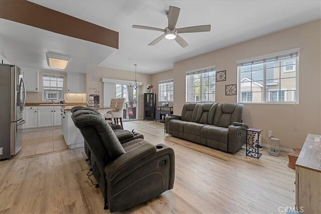 613 Flathead River St, Oxnard, CA 93036 - living room with healthy amount of natural light, light wood-style floors, a ceiling fan, and baseboards