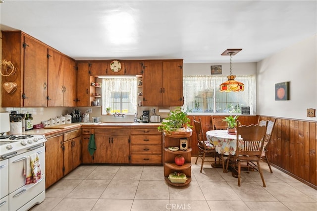 3095 Casitas Ave, Altadena, CA 91001 - kitchen with open shelves, white gas stove, brown cabinets, a wainscoted wall, and light countertops