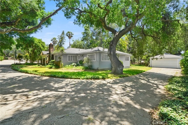 3095 Casitas Ave, Altadena, CA 91001 - ranch-style home with a detached garage, an outdoor structure, a front yard, and a chimney