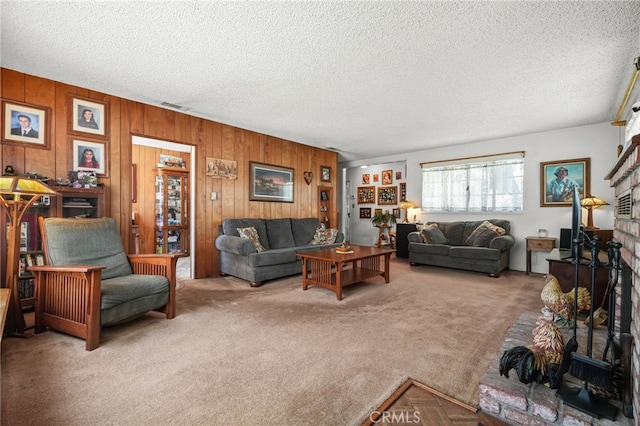 3095 Casitas Ave, Altadena, CA 91001 - living area with carpet, a textured ceiling, wooden walls, and a brick fireplace