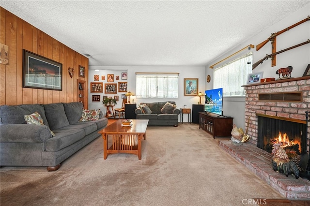 3095 Casitas Ave, Altadena, CA 91001 - carpeted living area with healthy amount of natural light, wood walls, a fireplace, and a textured ceiling