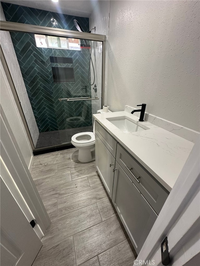 829 Foxworth Ave, La Puente, CA 91744 - bathroom with vanity, a textured wall, and a shower stall